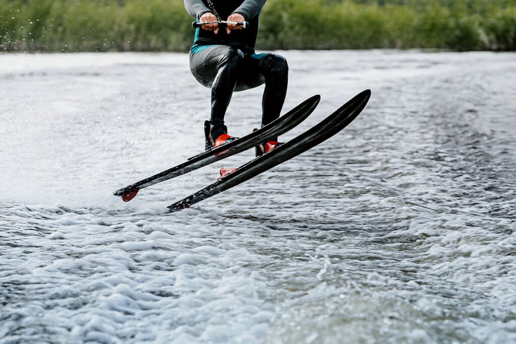 Man waterskiing on lake behind man waterskiing on lake behind